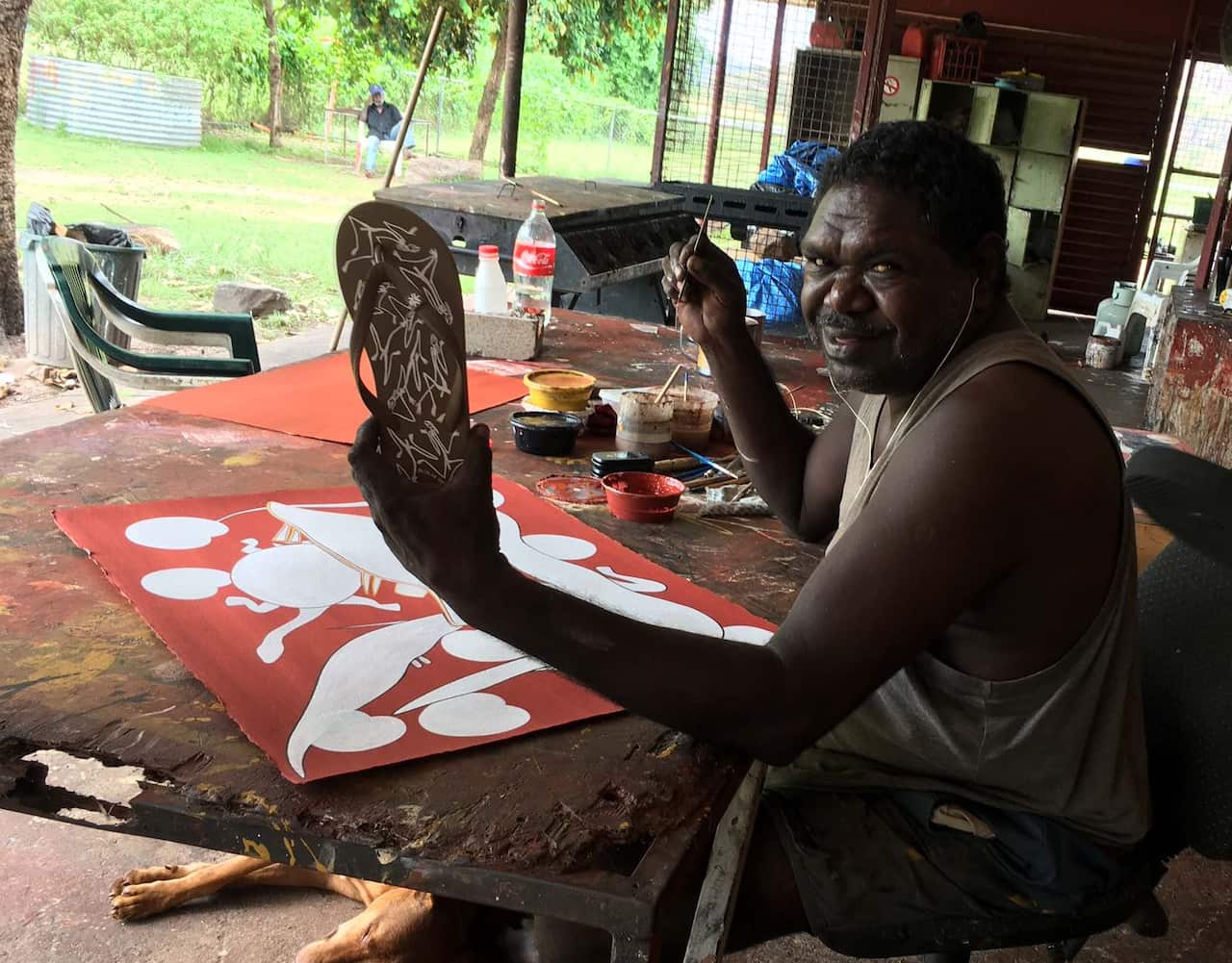 Gabriel in his studio, showing off his thong design (Mimihs).