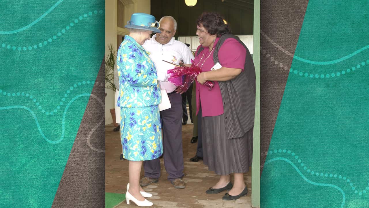 The Queen is presented with gifts of a boomerang and a nulla nulla by Greg McKellar and his wife Francis at the Muda Aboriginal Language Centre. 