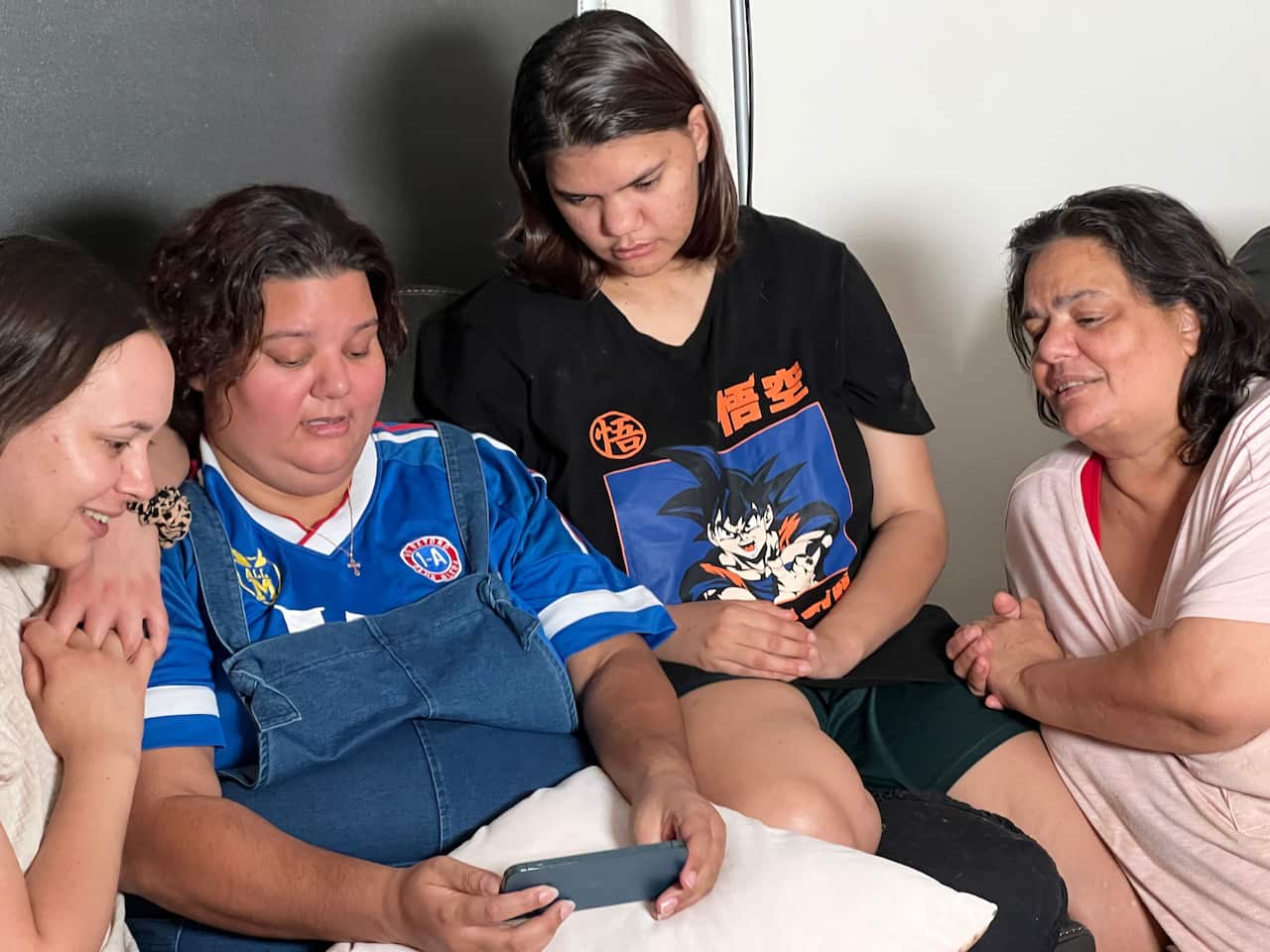 Ngala Kunoth-Monks (L) looks at photos of her late mother with family. 