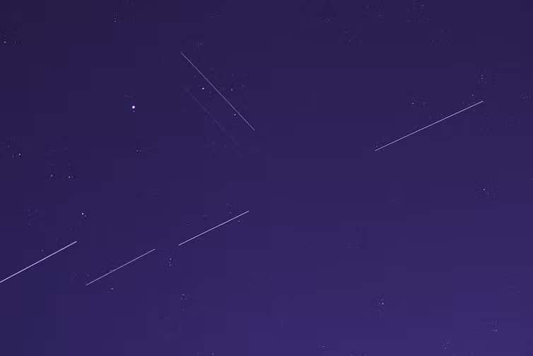 Satellites streak across the night sky