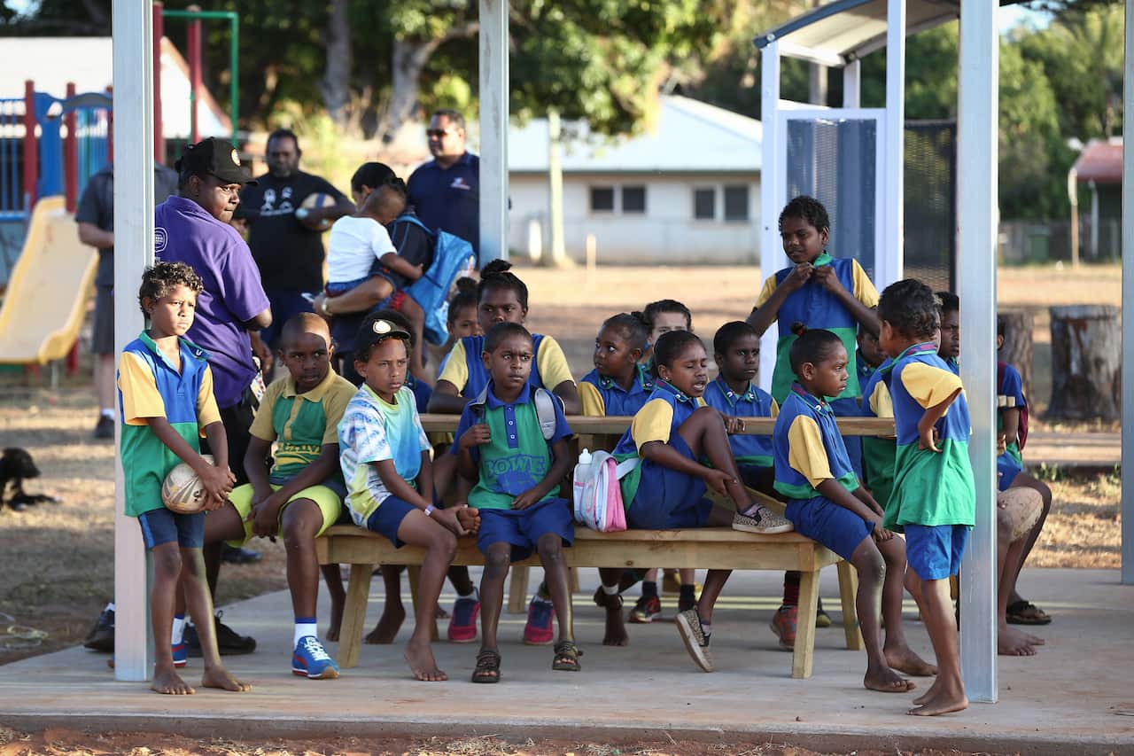 School children at the bus stop who are waiting for the Remote School Attendance Strategy (RSAS) bus to pick up school children for school in Bamaga, during Prime Minister Tony Abbott's visit to Cape York, on Wednesday 26 August 2015.