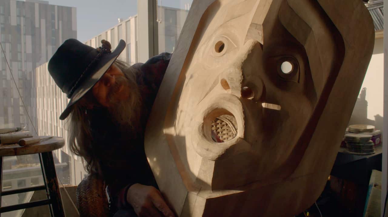 Beau Dick with his art work