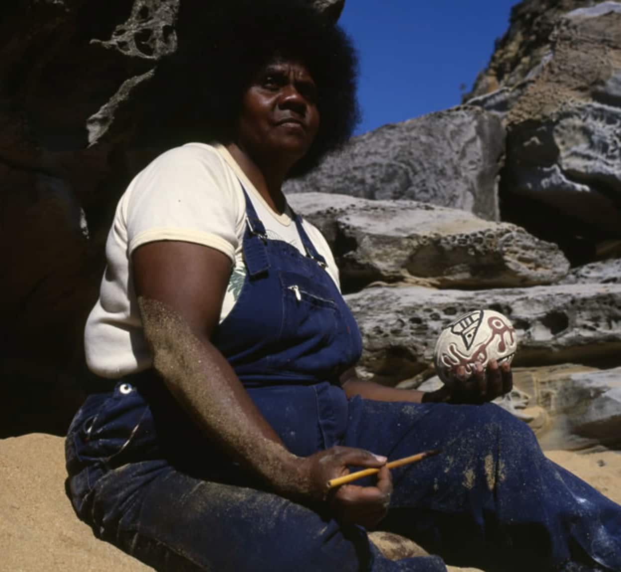 Thancoupie decorating a love magic egg, 1982.