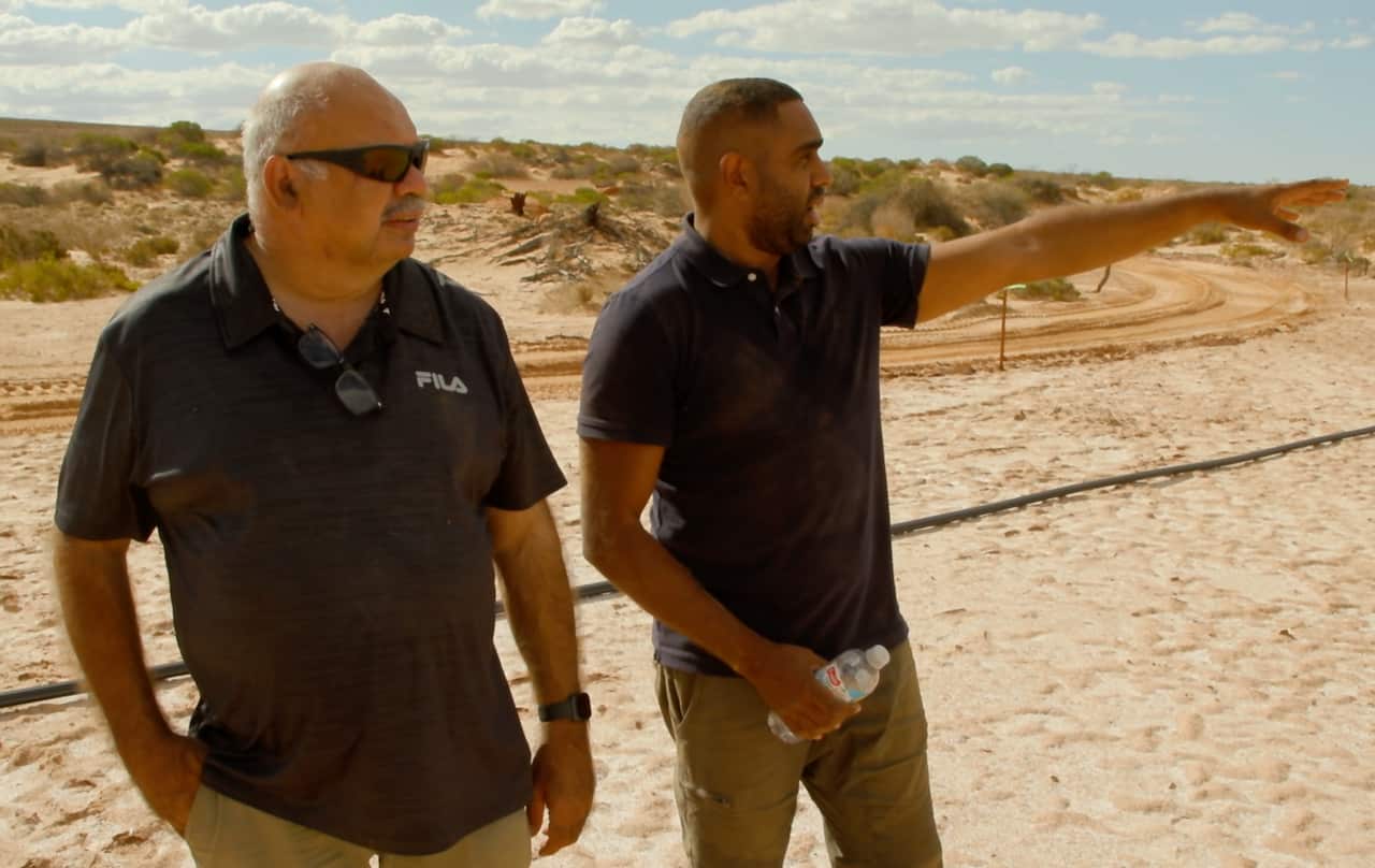 Kuyani man, Tony Clark explains how his ancestor's remains are spread across Lake Torrens to NITV journalist Douglas Smith. 