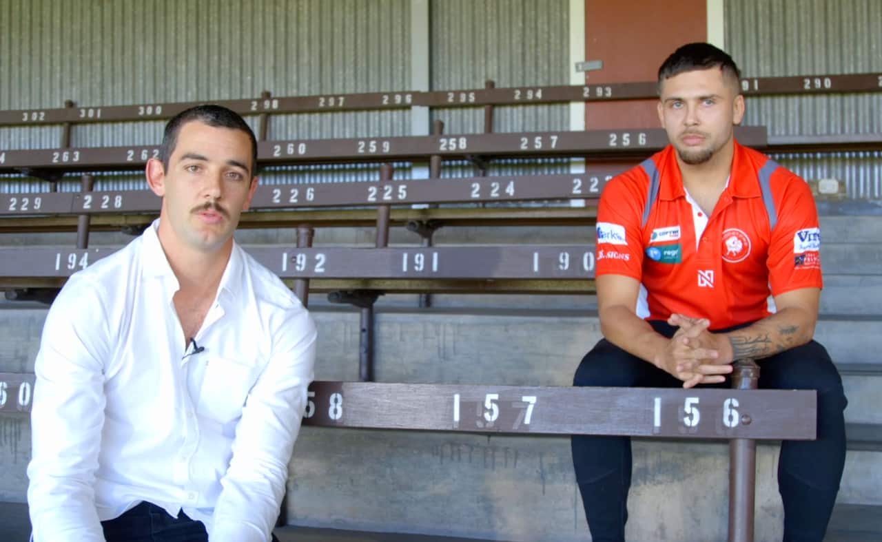 Taylor Walker sits in front of Robbie Young during an apology video, where he apologises for the racist comment he made while he was at a SANFL game last month.