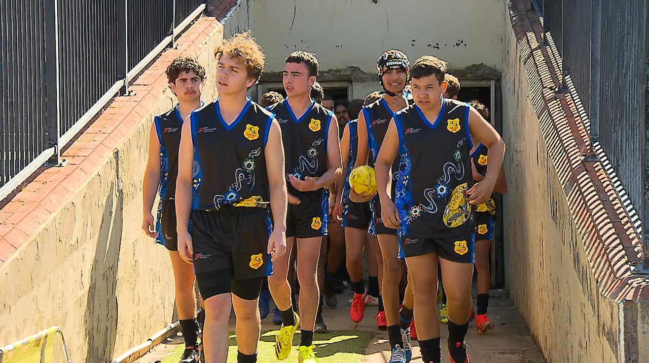 Players from the South Australian Aboriginal Junior representative side prepare to take to the field.