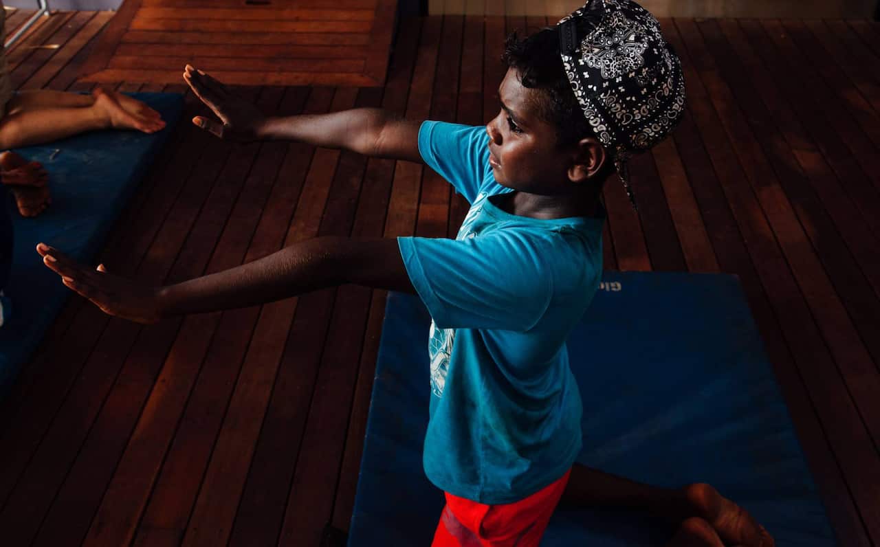 A young Yolngu boy practices Saman, an Indigenous dance from the province of Aceh in Indonesia