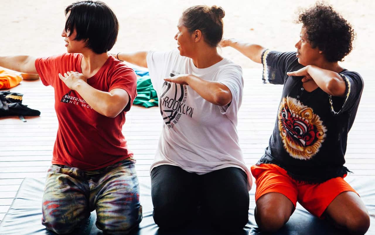 Rosealee Pearson (centre) performs Aceh's Saman dance with Alfira (left) and Murtala