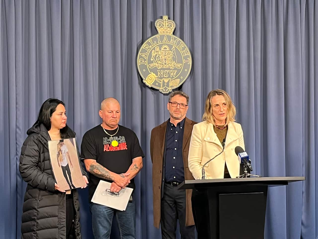 A group of people stand at a podium 