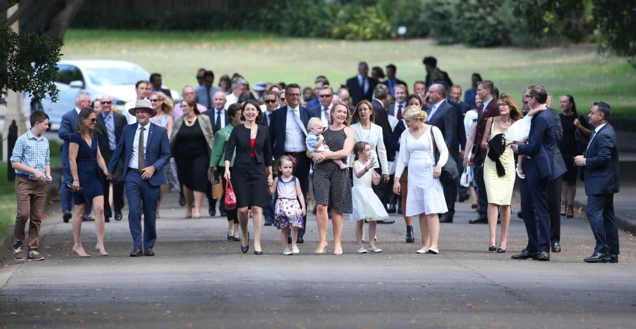 NSW Premier Gladys Berejiklian (4th left) walks with her colleagues and their families to a swearing-in ceremony at Government House in Sydney, Monday, Jan. 30, 2017. Berejiklian has sworn in her new ministry this afternoon
