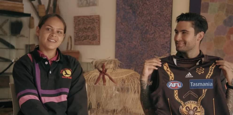 Artist Justine Ronberg & player Chad Wingard showing off her design