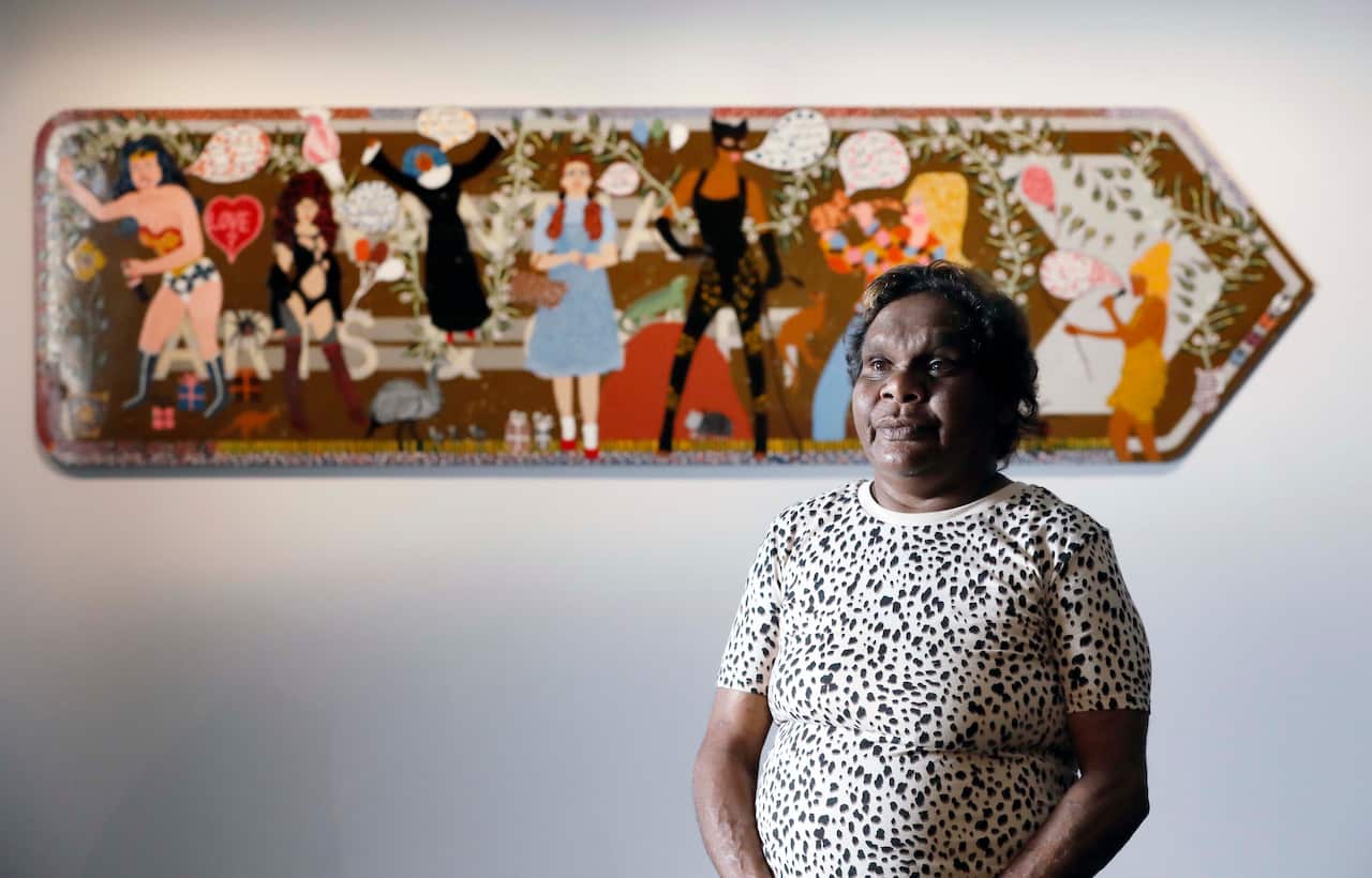 Telstra General Painting Award winner, Kaylene Whiskey, from Indulkana, SA, with her work “Seven Sistas”. National Aboriginal and Torres Strait Islander Art Awards.