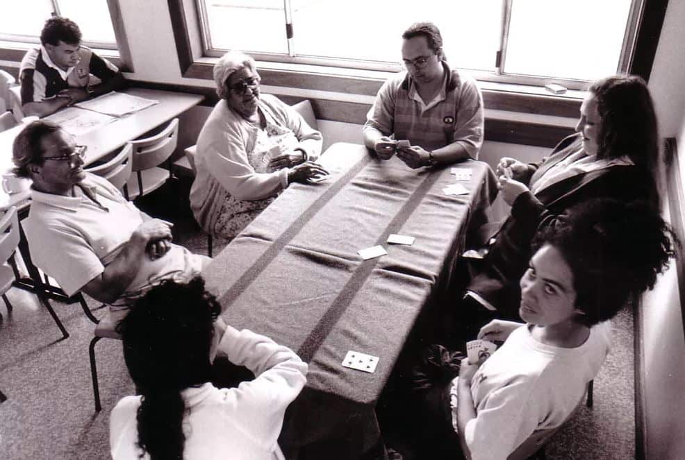 Isabel Flick playing cards with students at Tranby