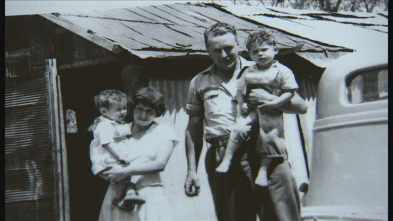 Glen's parents carrying his two sisters. 