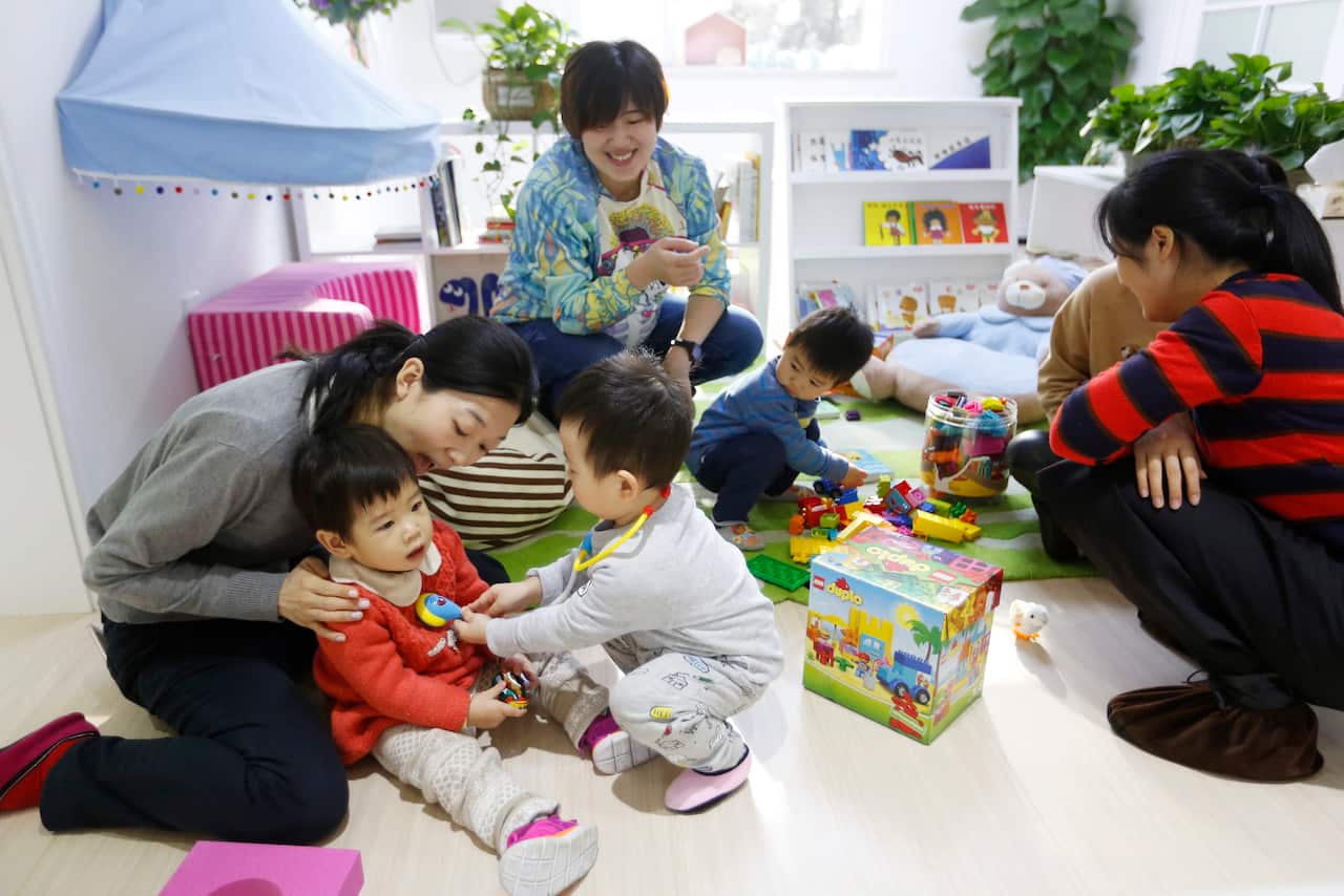 Chinese parents and their children playing together at the Magic International Daycare, a high end child care center in Beijing, China