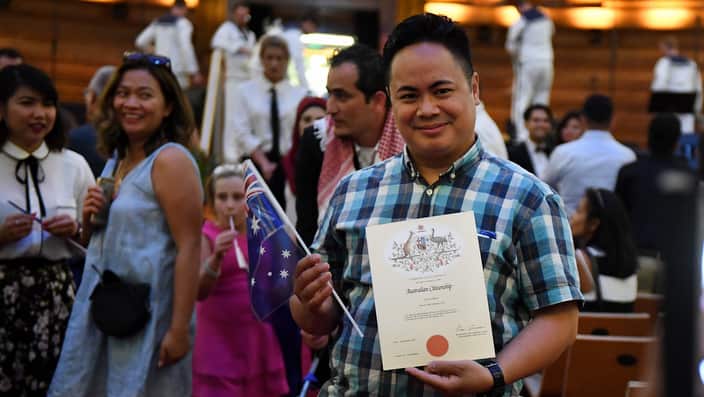 An Australian citizenship recipient poses for a photo after  a citizenship ceremony on Australia Day in Brisbane, Thursday, Jan. 26, 2017. (AAP Image/Dan Peled) NO ARCHIVING