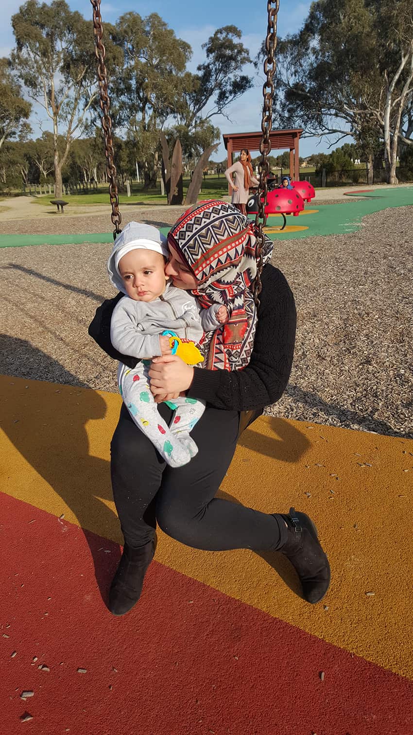 Afaf Alfawwal plays with her and her son, Zachariah in the park.