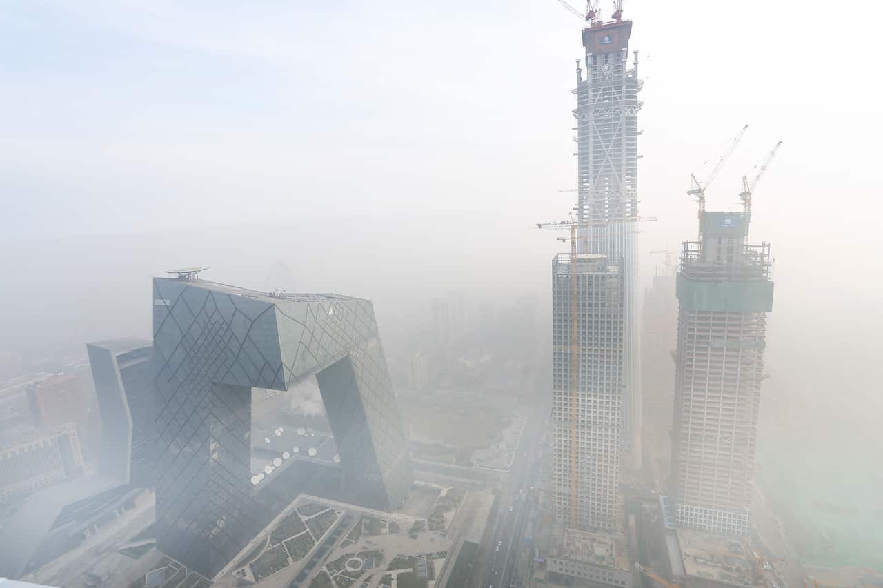 CCTV's iconic headquarters (left) through Beijing smog.