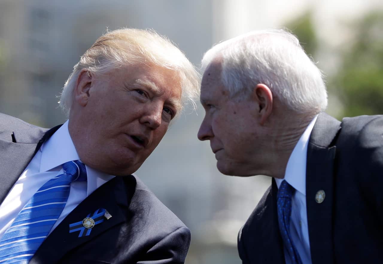 President Donald Trump talks with Attorney General Jeff Sessions, gestures before speaking at the 36th Annual National Peace Officers' memorial service, Monday, May 15. 2017, on Capitol Hill in Washington.  (AP Photo/Evan Vucci)