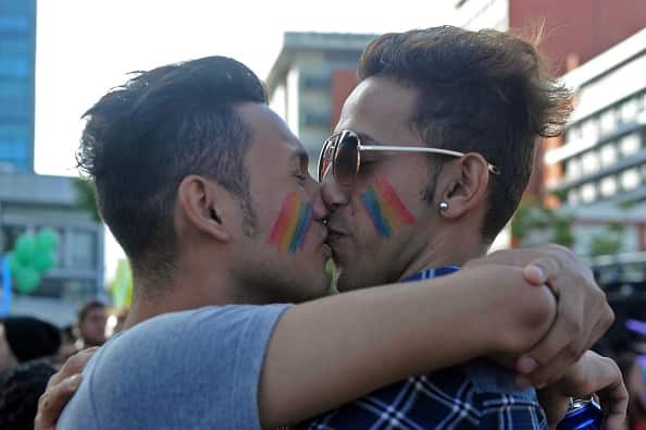 A gay couple kisses during the Gay Pride Parade in Guatemala City, on June 27, 2015. AFP PHOTO/Johan ORDONEZ        (Photo credit should read JOHAN ORDONEZ/AFP/Getty Images)