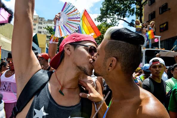 Two men kiss during the Gay Pride Parade in Caracas on July 12, 2015.   AFP PHOTO / FEDERICO PARRA        (Photo credit should read FEDERICO PARRA/AFP/Getty Images)