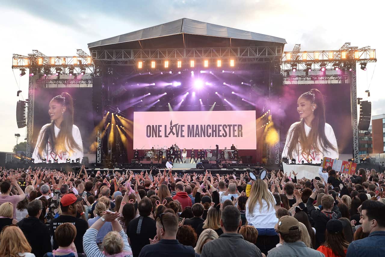 Ariana Grande, centre in white, performs at the One Love Manchester tribute concert in Manchester, north western England, Sunday, June 4, 2017.    