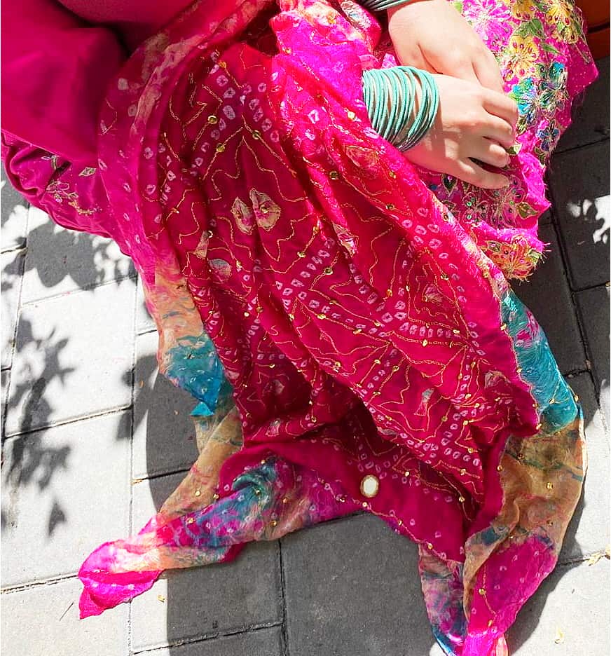 Close up of patterns on the salwar kameez, with mirrors and metallic threads.