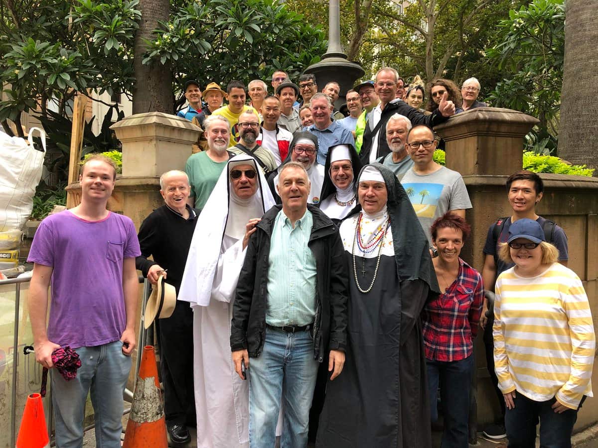 The tour group standing on the stairs that once housed a popular Wynyard Park beat.