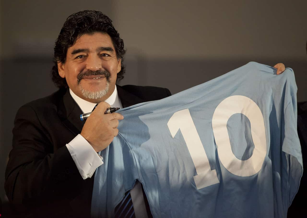Football legend Argentinian Diego Maradona with a SSC Napoli number 10 jersey during a press conference on February 26, 2013 in Naples. 