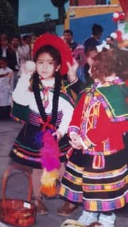 Young girl of Peruvian descent wearing traditional clothing.