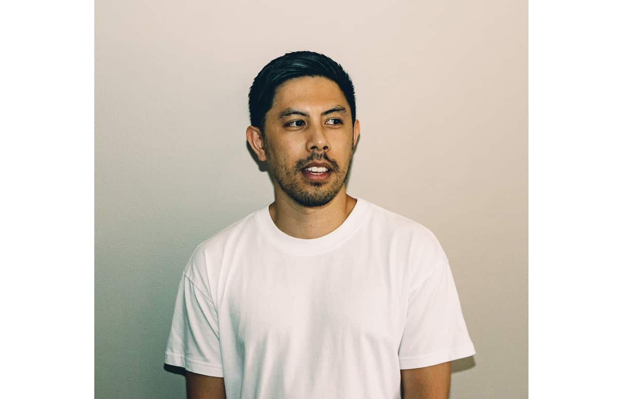 Asian man looking away from camera.