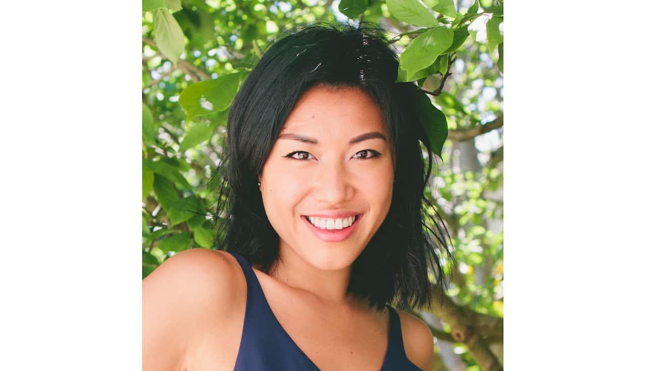 Young Asian woman smiling at camera