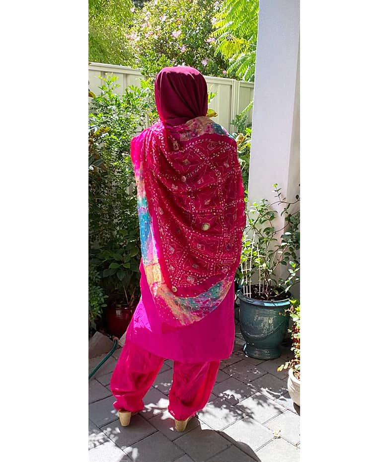 Full length view from behind of the richly decorated salwar kameez set.