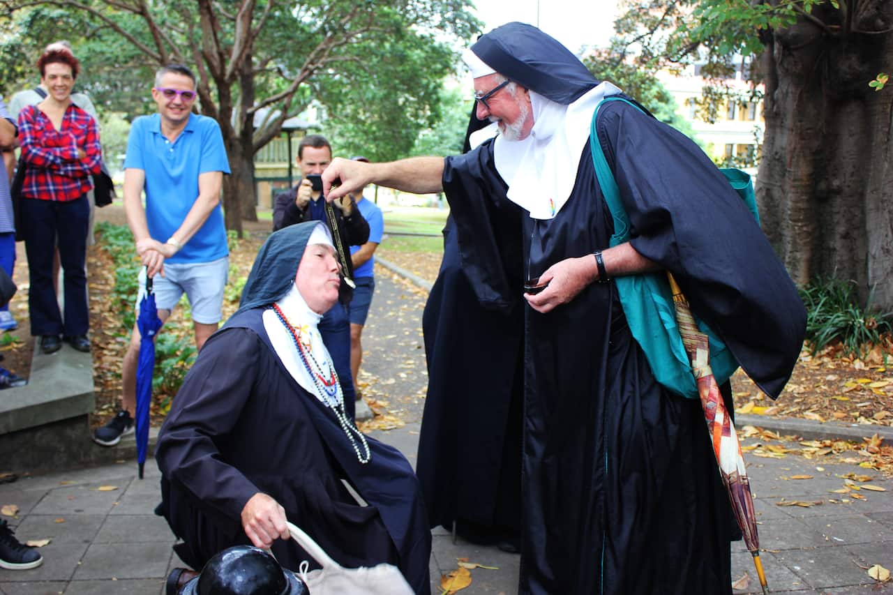 Sister Catheter of the Sacred Immaculate Ejaculate, who rose to the ranks of sister only a month before, kisses the sacred relic.