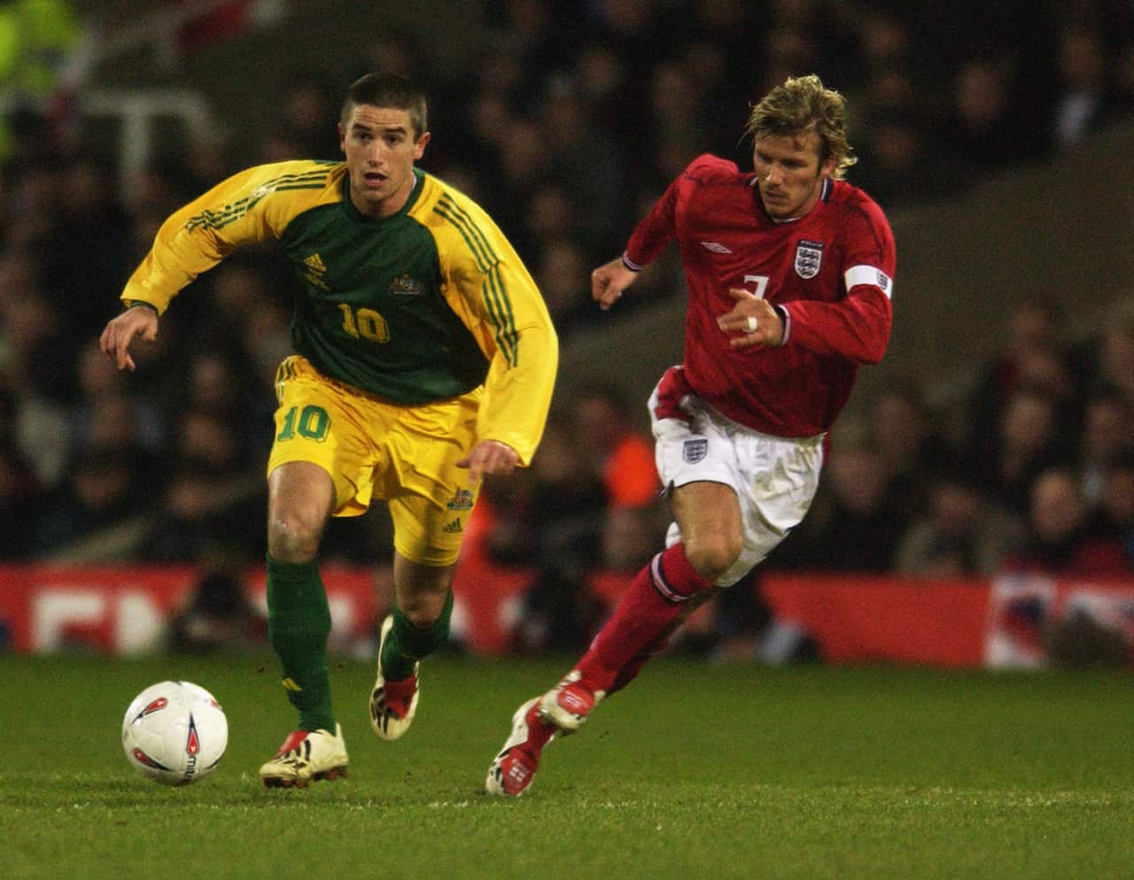 David Beckham attempts to catch Harry Kewell