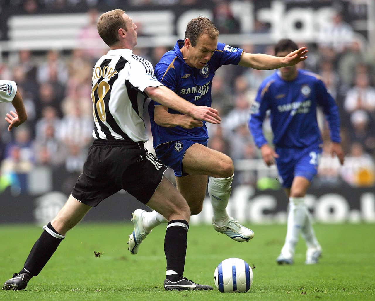 Newcastle United's Craig Moore (L) clash