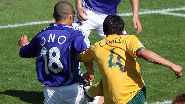 Australian midfielder Tim Cahill (R) scores