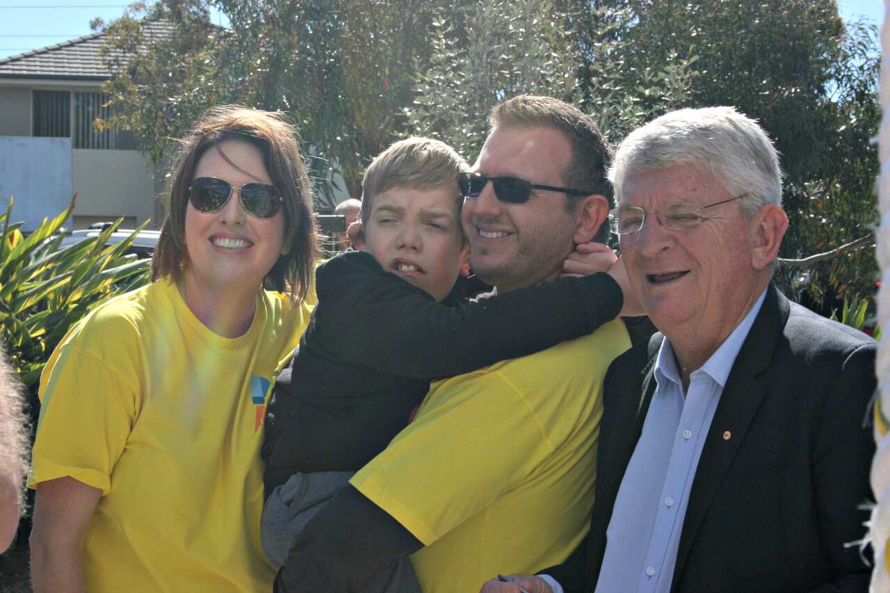 Caroline Ghatt, Tim Smith and their son Marcus celebrate the playground opening with Northern Beaches Council administrator Dick Persson 