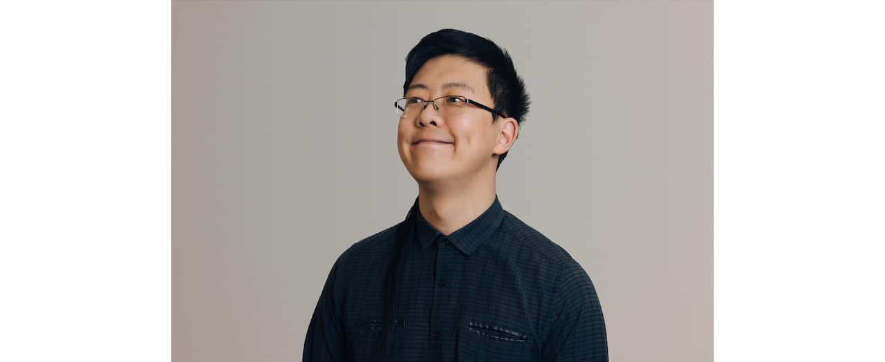 Man smiling looking away from camera.