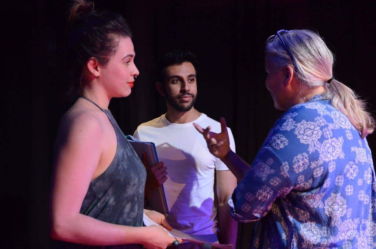 Director Suzanne Millar talks to actors during rehearsals for The Laden Table