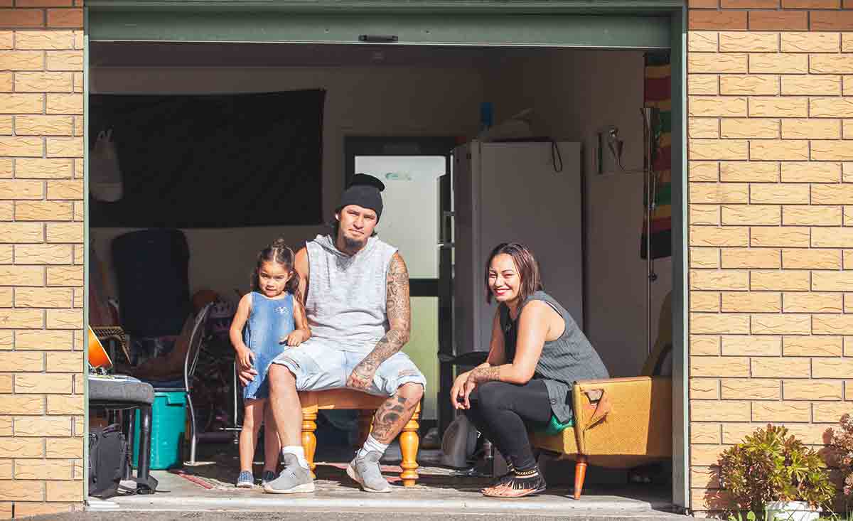 Maori family sitting in their garage