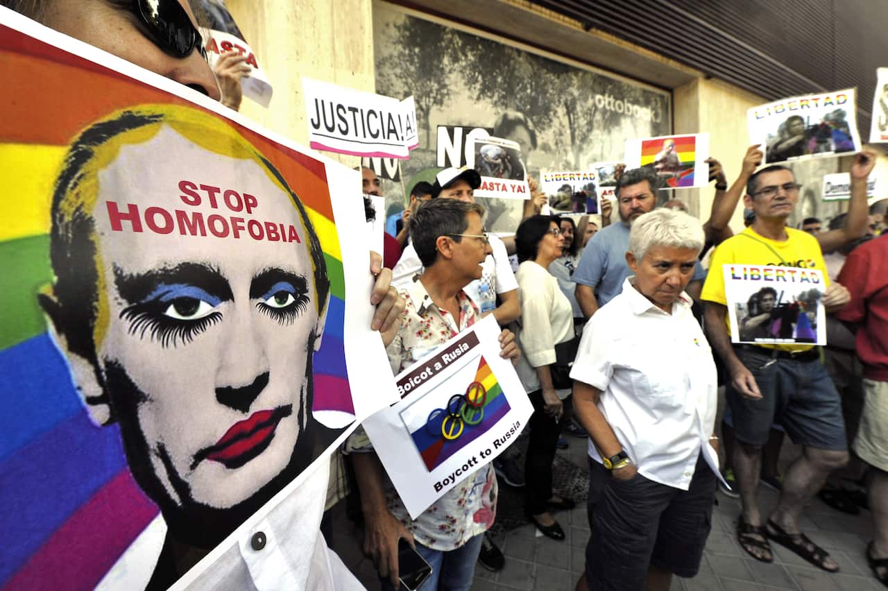Demonstrators hold up anti-Putin placards at rally at Russian embassy in Spain, 2013.