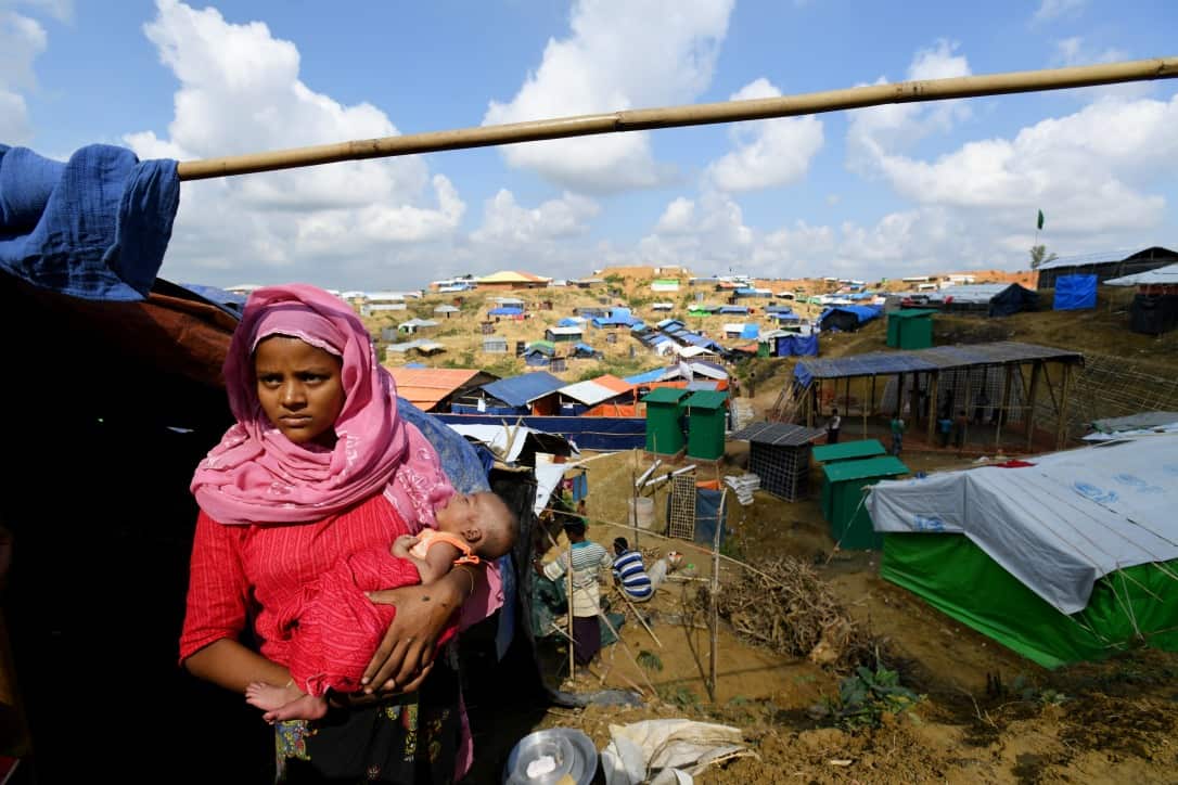 Rohingya refugee Janet Ara with her 27-day-old boy Mohammad Arshat in front of their shack at the Balukhali refugee camp in Bangladesh on December12, 2017.