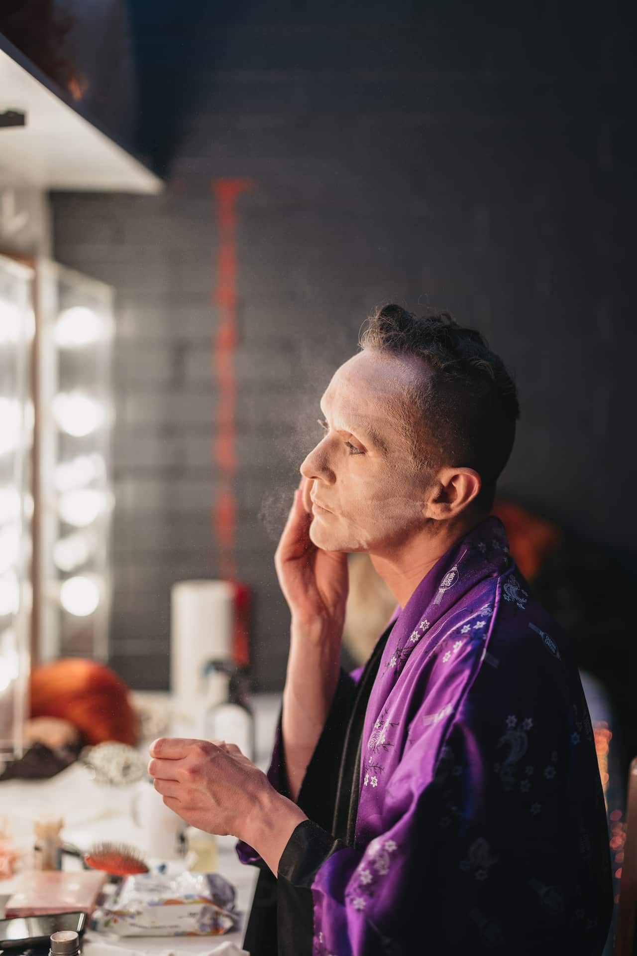 Clint Stringberg in the dressing room of His Majety's Theatre, powdering their face in preparation to emerge as Cougar Morrison.