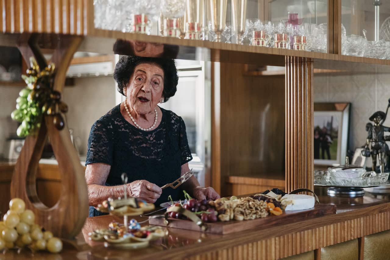 Nina potters in the kitchen