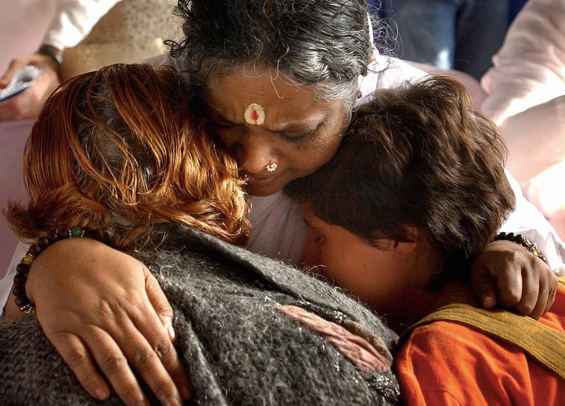 Hindu teacher Mata Amritanandamayi, UN Gandhi Prize 2002, known worldwide as 'Mother Compassion' hugging local residents in Barcelona, Spain.