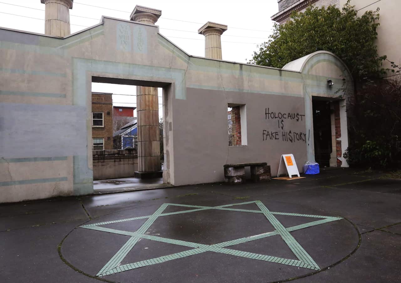 Anti-Semitic Holocaust-denying graffiti is seen on the facade of Temple De Hirsch Sinai in Seattle (USA) on March 10, 2017.