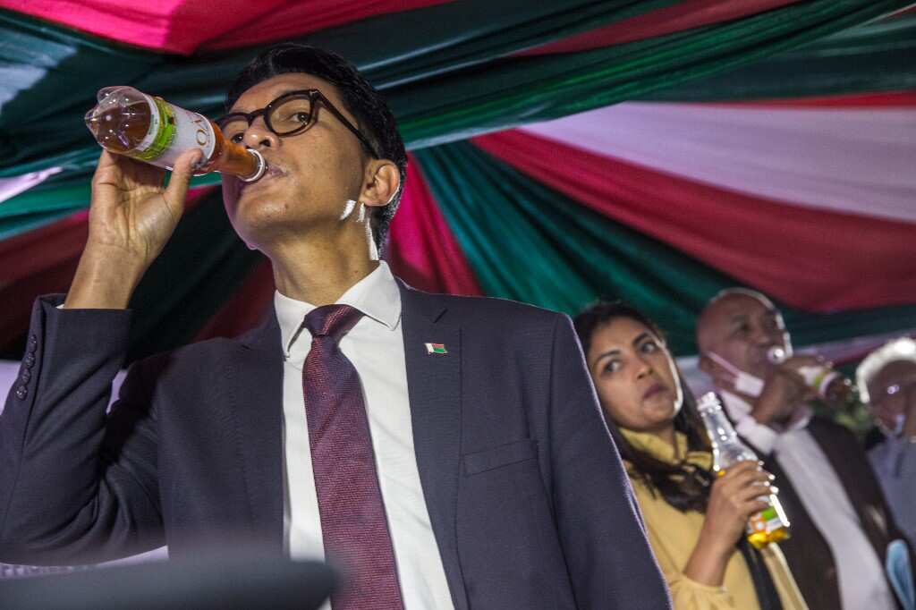 Madagascar's President Andry Rajoelina drinks a sample of the "Covid Organics" or CVO remedy at a launch ceremony in Antananarivo