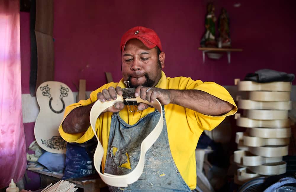 Mexican luthier Salvador Meza, makes a replica guitar from "Coco" the movie at his workshop, in Paracho, Michoacan state.