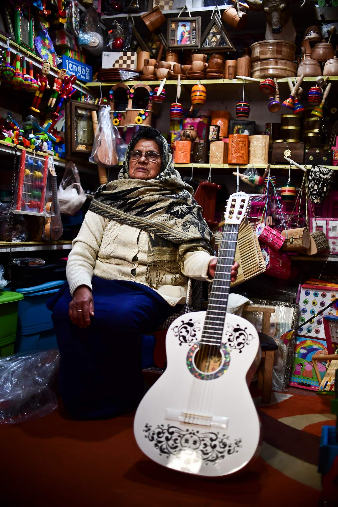 A woman sells replica guitars from "Coco" the movie at her stall in Paracho, Michoacan state.